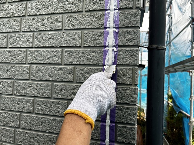 飯田市：外壁サイディングの目地に充填したコーキングをヘラ押さえ